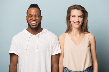 Fototapeta premium Happy smiling multiracial couple standing next to each other.