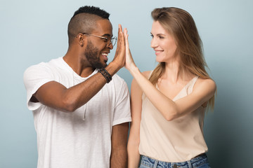 Happy multiracial family couple giving high five to each other. 