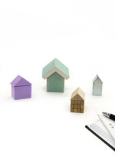 Various model houses, an agenda, plans and a pen.