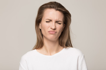 Obraz premium Portrait unhappy young woman with closed eyes feeling upset