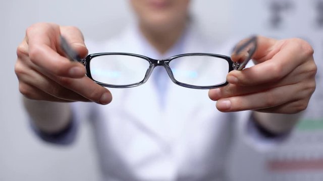 Doctor suggesting eyeglasses for person with refocused vision, sight improvement