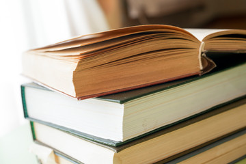 Open book, hardback books on bright colorful background.