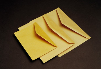 Examples of different sizes of yellow envelopes to send letters, paperwork, and so on.