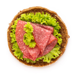 Sandwich with salami sausage on white background.