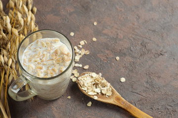 A Cup of milk with cereal on a brown concrete table. Healthy and healthy Breakfast