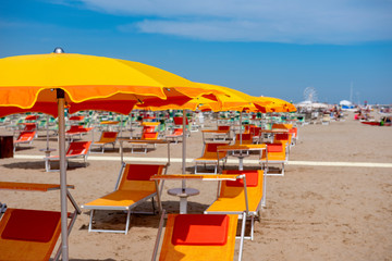 Sun umbrellas, sun beds, beach, Rimini, Italy.