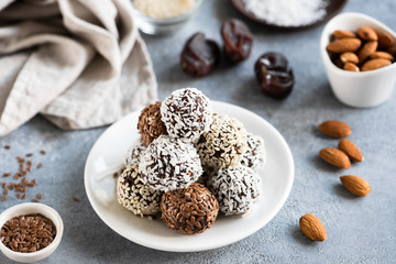 Chocolate protein truffles or vegan candy or energy balls with seeds, dates and nuts
