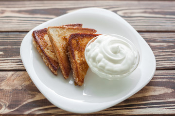 Morning breakfast. Toasts with strawberry and jam. Bread and confiture. Fresh hot toasts with cream. Delicious homemade dessert.