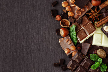 Chocolate on dark stone background. Top view with copy space