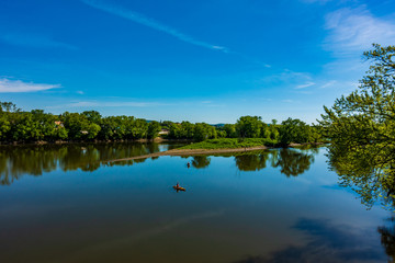 Fototapeta na wymiar landscape with lake, blue sky and canoes