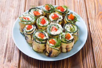 Zucchini rolls with cream cheese , tomatoes and dill