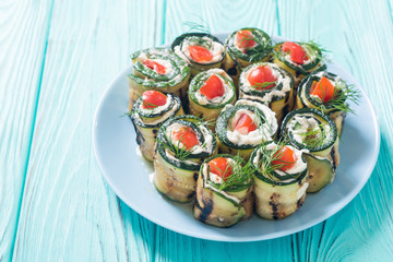 Zucchini rolls with cream cheese , tomatoes and dill