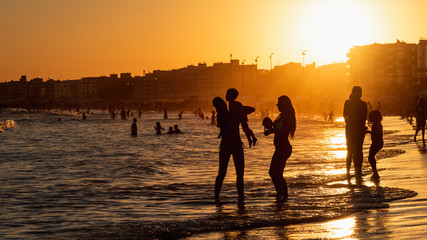 Mother and son on the beach at sunset