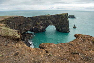 Dyrholaey rock arch in the Atlantic ocean, Iceland