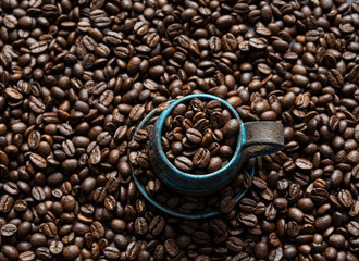 frersh aroma coffee beans on blue cup top view background