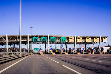 Expressway checkpoint on the expressway and rush hour at sunset.toll road, toll highway in europe.Cars passing through the automatic point of payment on a toll road. Russian highway.charging point