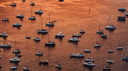 Yachts on the sunset in orange sea 