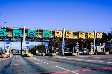 Expressway checkpoint on the expressway and rush hour at sunset.toll road, toll highway in europe.Cars passing through the automatic point of payment on a toll road. Russian highway.charging point