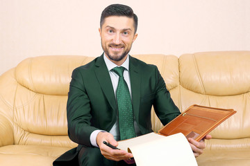 successful business man smiling with business documents