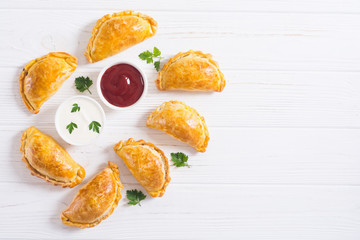Latin American baked beef empanadas with sauce
