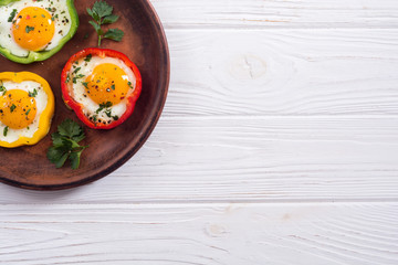 Yellow , red and green pepper with fried eggs