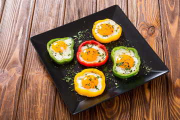 Yellow , red and green pepper with fried eggs