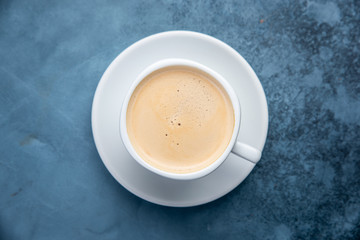 black coffee on blue pastel color background. Top view. Flat lay style