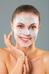 beautiful young woman with a cleansing mask on her face