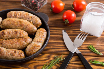 Grilled sausages with tomatoes , pepper and rosemary