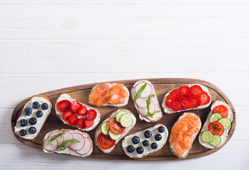Variation of toast with fruit , vegetable and salmon