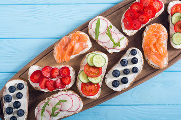 Variation of toast with fruit , vegetable and salmon