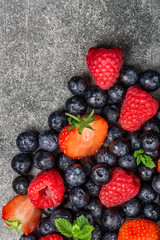 Fresh summer berries such as blueberries, strawberries, raspberries, top view