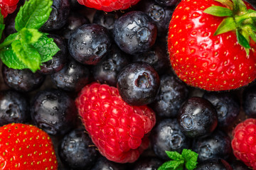 Fresh summer berries such as blueberries, strawberries, raspberries, top view