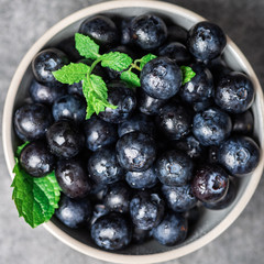 Fresh summer berries such as blueberries in the bowl, top view