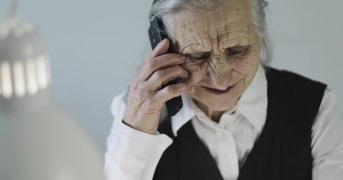 Grandmother speaking on the mobile phone indoors.