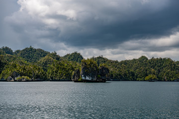 Fototapeta premium Waigeo, Kri, Mushroom Island, group of small islands in shallow blue lagoon water, Raja Ampat, West Papua, Indonesia