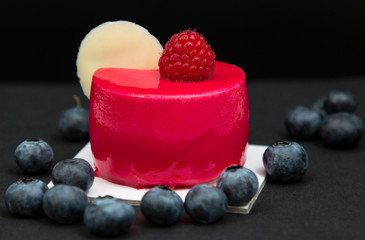 New beautiful stylish red cake with raspberries