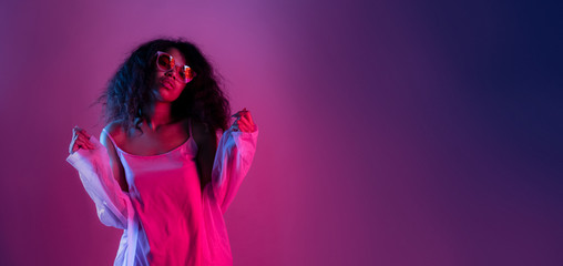 Fashion young african girl black woman wear stylish pink glasses clothes looking at camera isolated on party purple studio background, horizontal banner for website design, portrait, copy space