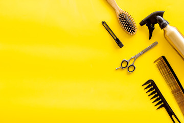 Set of professional hairdresser tools with combs and styling on yellow background top view mock up