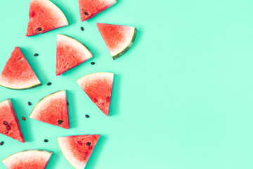 Watermelon pattern. Red watermelon on mint background. Summer concept. Flat lay, top view, copy space - obrazy, fototapety, plakaty