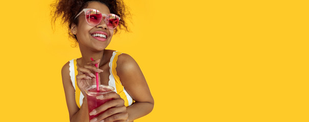 Happy young african woman holding drink wear glasses laughing, cheerful black teen girl enjoy...