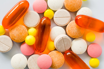 Assorted colorful tablets, pills, drugs on white background. Medication and healthcare concept.