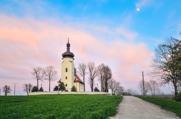 Beautiful church on the hill in the evening scenery. Church of St. Clement in Lędziny in Poland.