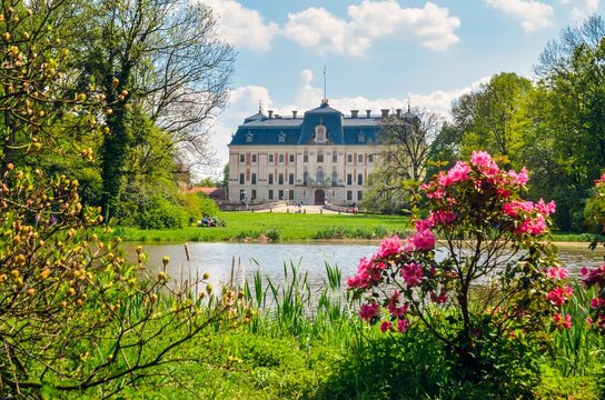 Beautiful historic castle in colorful spring scenery. Neo baroque castle in a park in Pszczyna in Poland.