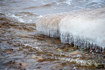 pieces of frozen ice in the lake in dim winter day