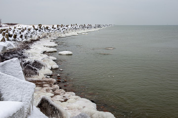 pieces of frozen ice in the lake in dim winter day