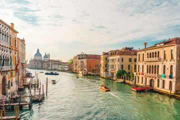 Obraz na płótnie Canvas view of the Grand Canal and Basilica Santa Maria della Salute during sunrise with boats, Venice, Italy