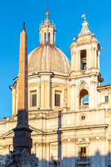 Fototapeta na wymiar Four Rivers Fountain, Italian Fontana dei Quattro Fiumi, with obelisk and St Agnes Church on background. Piazza Navona square, Rome, Italy