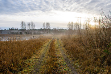 wet damp hiking tourist trail with snow leftovers on the sides