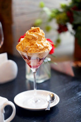 Delicious sweet dessert with cream and raspberry